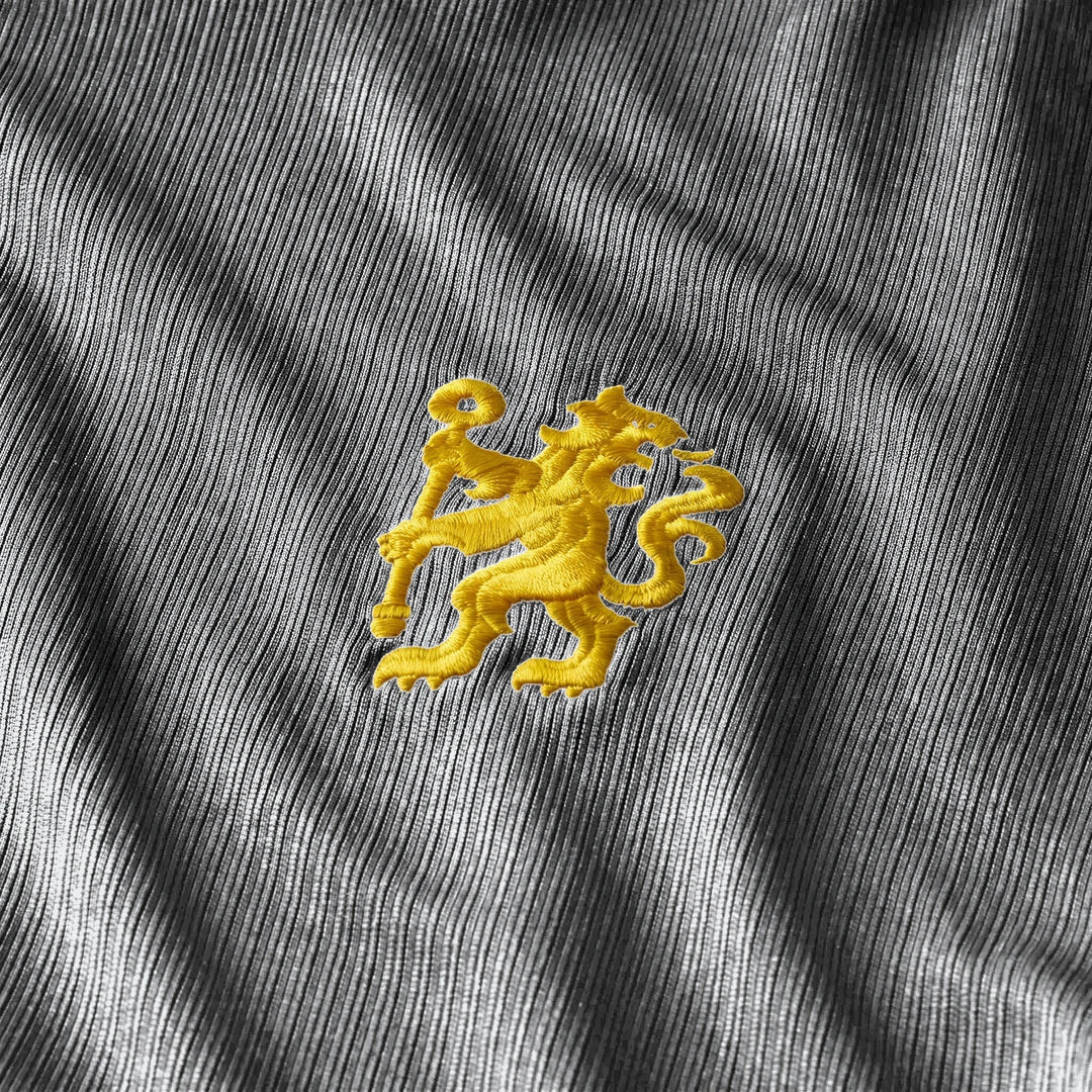 Close-up of the yellow embroidered lion logo on the black Chelsea FC 2026/27 Stadium Away Men's Nike Dri-Fit Soccer Replica