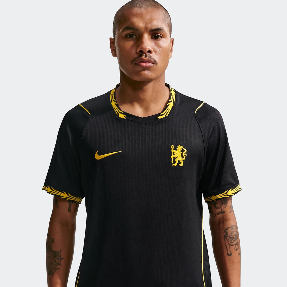 Chelsea FC 2026/27 Stadium Away Men's Nike Dri-Fit Soccer Replica Jersey in black with yellow accents, worn by a male model.