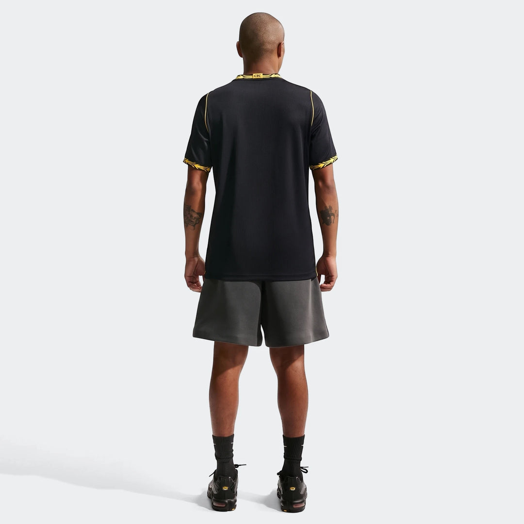 Men's Chelsea FC 2026/27 Stadium Away Nike Dri-Fit soccer replica jersey in black and yellow, worn by a model from the back.