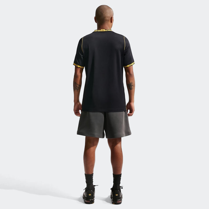 Men's Chelsea FC 2026/27 Stadium Away Nike Dri-Fit soccer replica jersey in black and yellow, worn by a model from the back.