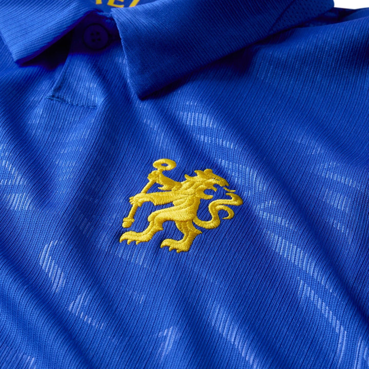 Blue Nike Dri-Fit Chelsea FC 2026/27 Stadium Home replica jersey close-up, featuring an embroidered yellow lion crest.