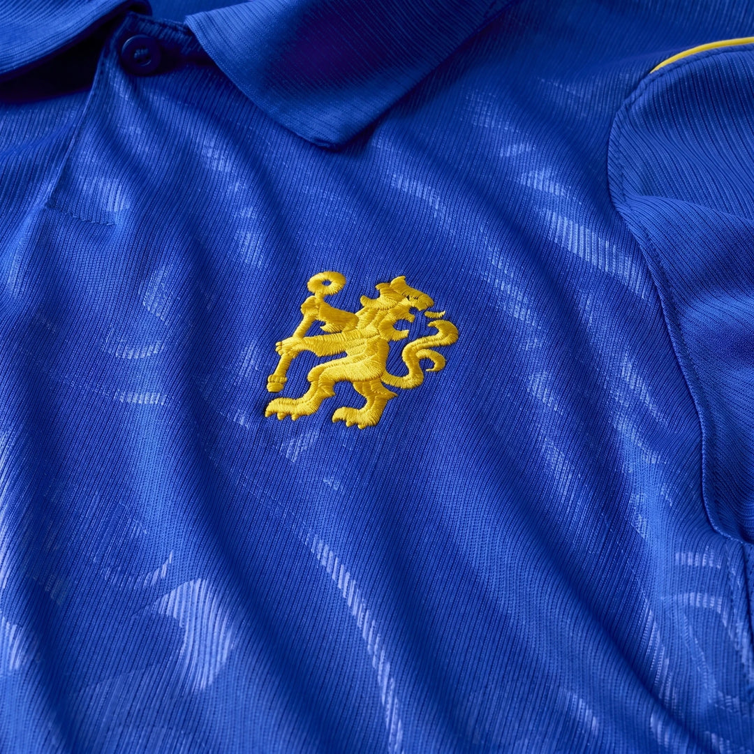 Close-up of a men's blue Chelsea FC 2026/27 Stadium Home Nike Dri-Fit soccer replica jersey featuring the yellow lion logo.