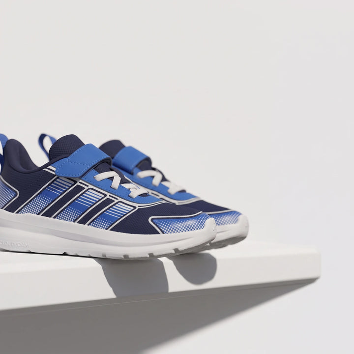Children's Adidas Tensaur Run 4.0 shoes in navy blue and bright blue with white soles and velcro straps, displayed on a