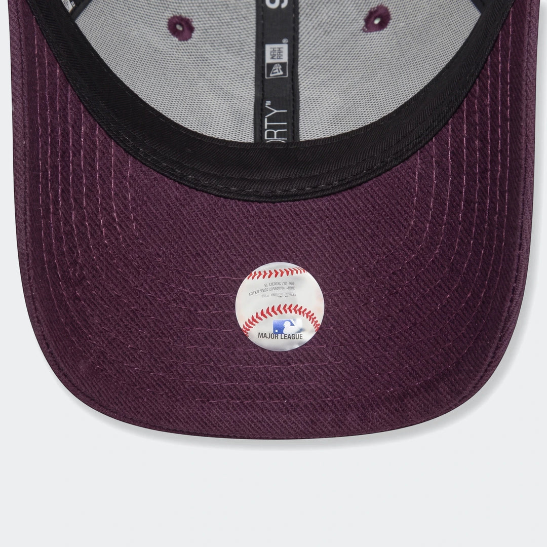 Underside view of a Chyt League Ess purple baseball cap, showing the brim, internal gray fabric, and an MLB sticker.