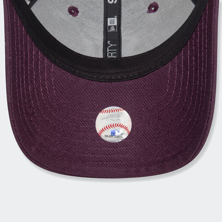 Underside view of a Chyt League Ess purple baseball cap, showing the brim, internal gray fabric, and an MLB sticker.