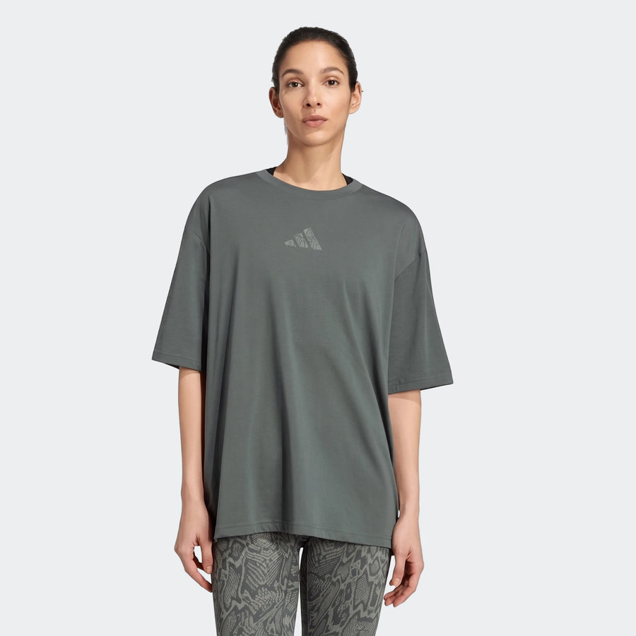 Woman wearing an oversized gray-green Adidas Climacool Animal Training Graphic T-Shirt and gray patterned leggings.