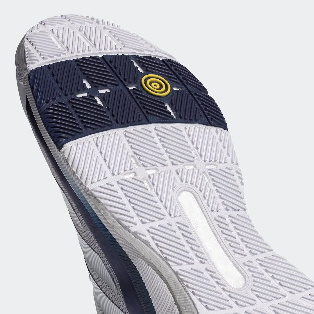 A close-up view of the white, navy, and yellow sole of a Crazyquick Boost Padel Shoe, showcasing the detailed tread pattern.