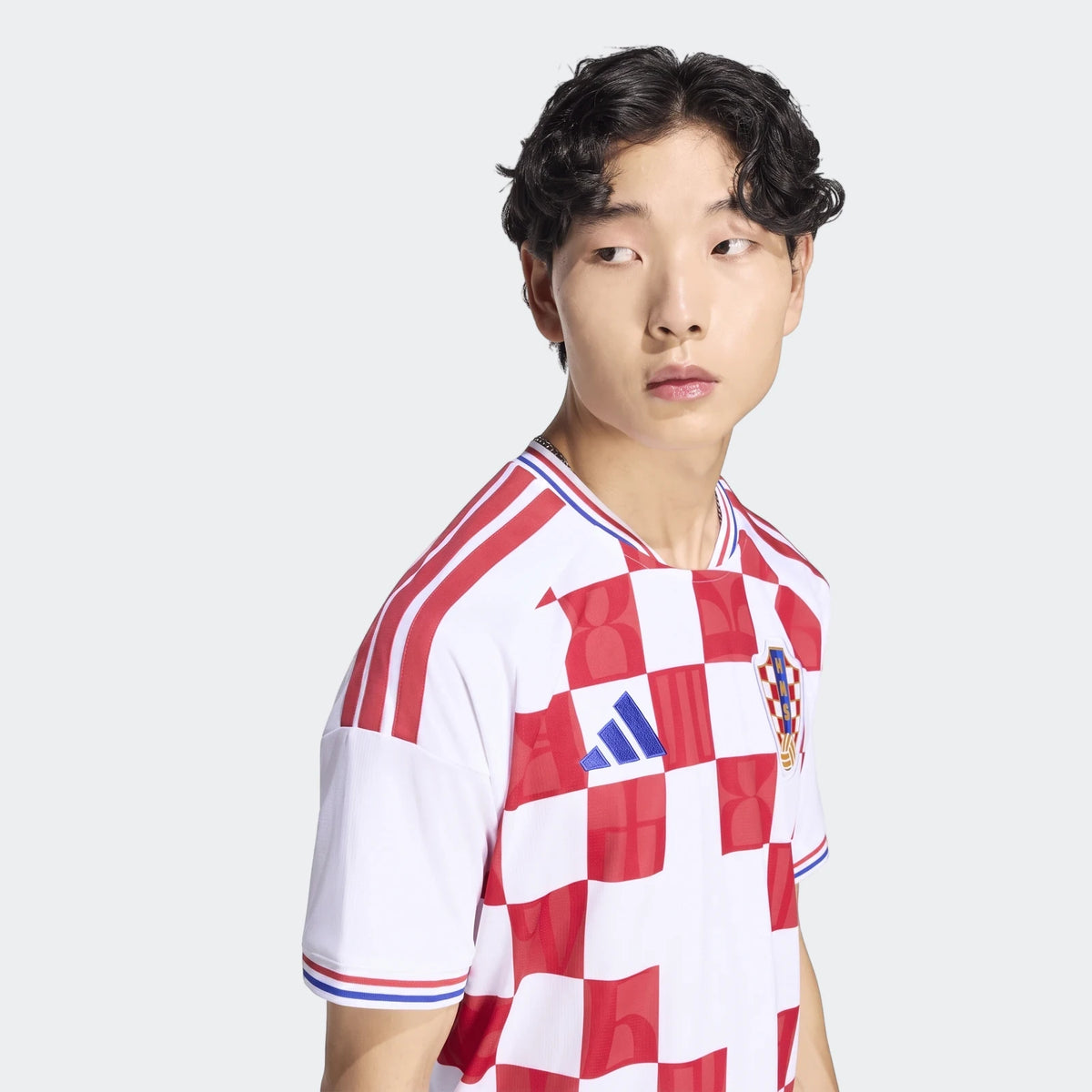 Croatia 26 Home Jersey in white and red checkered pattern, featuring the Adidas logo and Croatia crest, worn by a male model