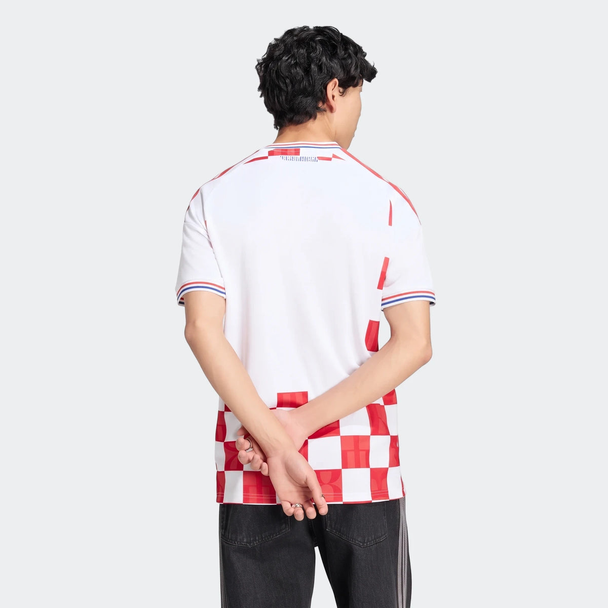 Rear view of a men's white Croatia 26 Home Jersey featuring a red and white checkered pattern and red shoulder stripes.