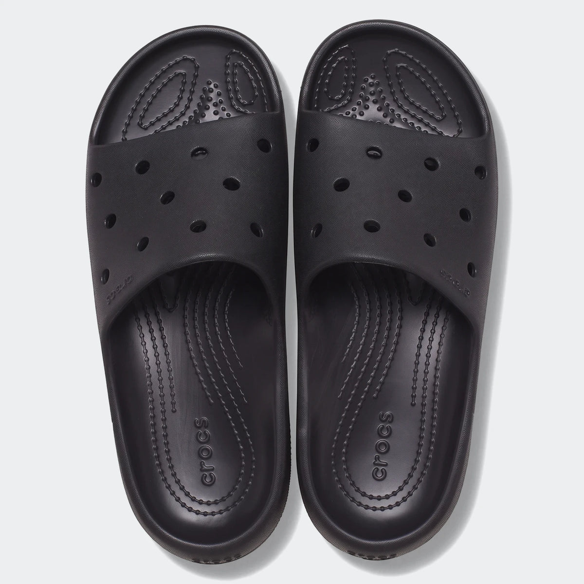 Top-down view of black Crocs Classic Slide V2 slides, featuring comfortable textured footbeds and ventilation ports, ideal