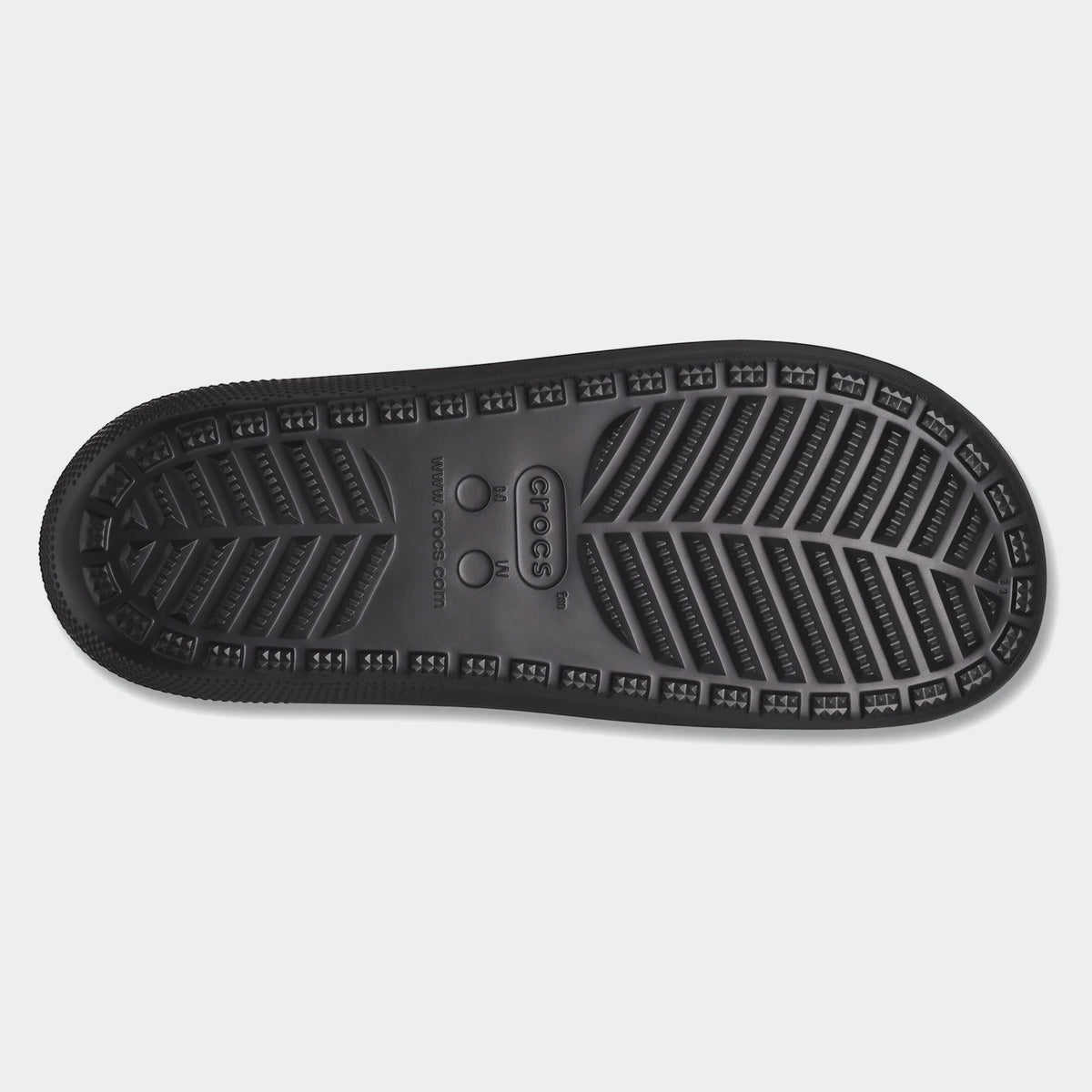 Black Crocs Classic Slide V2 sole, viewed from the bottom, showcasing its textured grip pattern and branding.