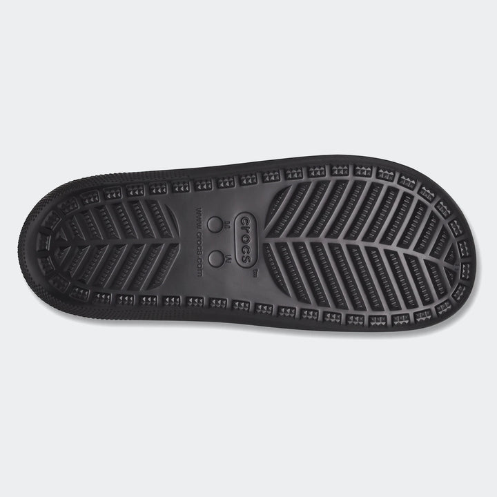Black Crocs Classic Slide V2 sole, viewed from the bottom, showcasing its textured grip pattern and branding.