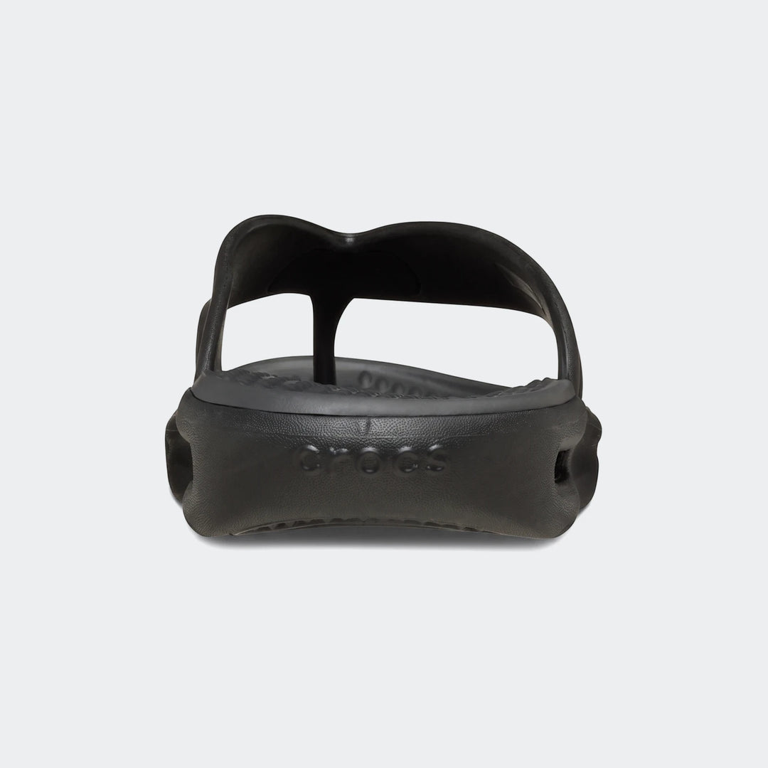 A single black Crocs In Motion Lite Ride flip-flop, made of comfortable molded foam, is shown from a front-facing low angle