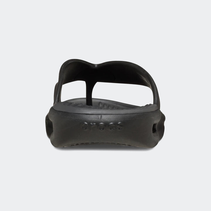 A single black Crocs In Motion Lite Ride flip-flop, made of comfortable molded foam, is shown from a front-facing low angle