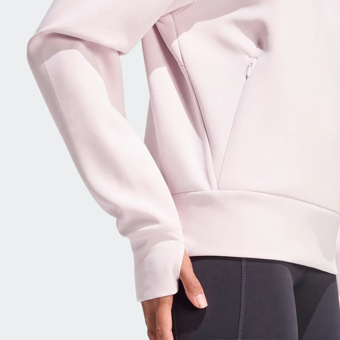 A close-up shot of a light pink D4T Knit Crew Sweatshirt, featuring knit fabric and thumbhole sleeves.