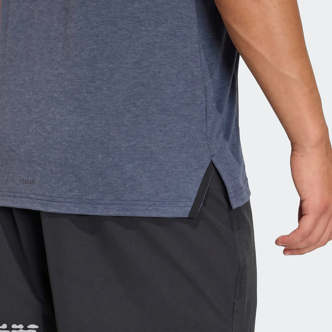 Close-up of a men's D4T T-shirt in heathered blue with a split hem, worn by a model with dark shorts.