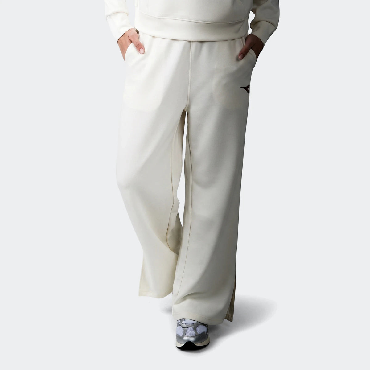 Cream Diadora Danielle Trackpant for women, shown on a model from the waist down, featuring a wide-leg design and an