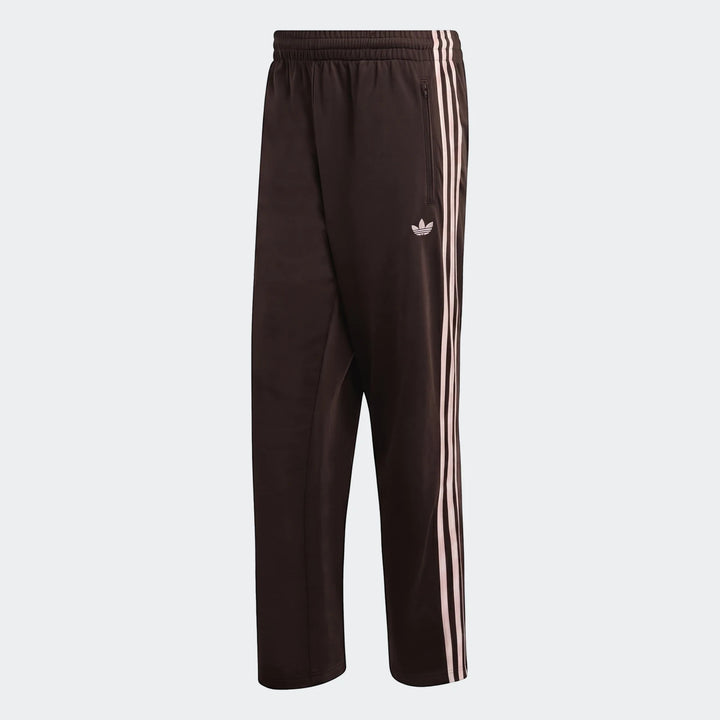 Dark brown Adidas Firebird track pants for men, featuring iconic white three-stripes and a Trefoil logo on the side,