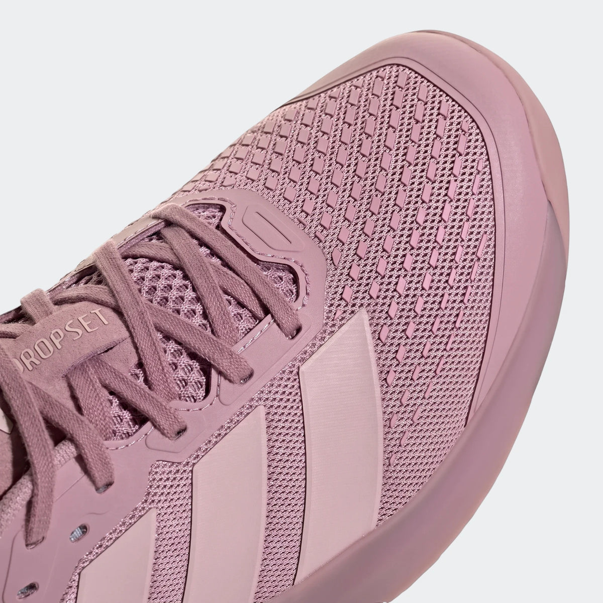 Close-up of a pink Adidas Dropset 4 Training shoe, showcasing the mesh upper and laces from a top-down angle.