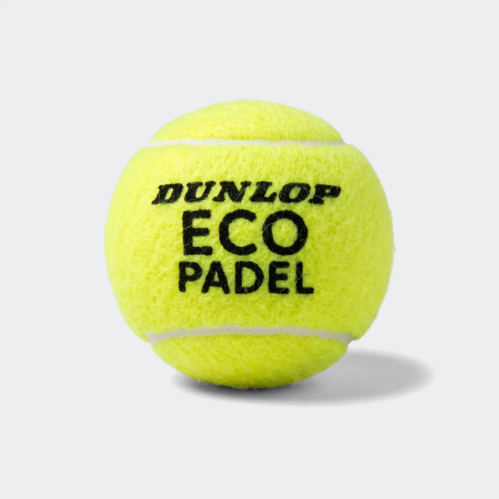 Close-up of a single yellow Dunlop Eco Padel ball with black 'DUNLOP ECO PADEL' logo and white stitching, for padel sport.