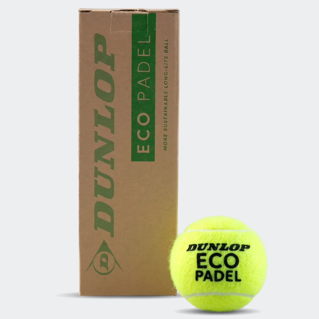 A single yellow Dunlop Eco Padel ball sits next to its brown cardboard packaging, featuring eco-friendly branding.