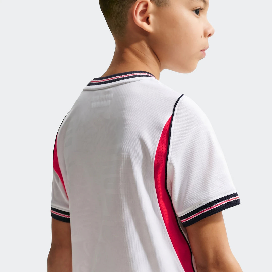 Young boy wearing the England National Team 2026 Stadium Home White Nike Dri-Fit Soccer Jersey in a profile view.