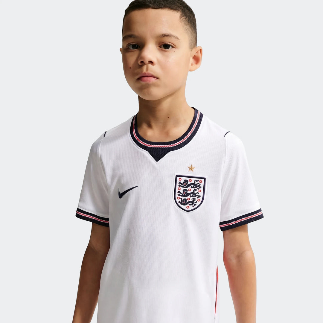 Young boy wearing an England National Team 2026 Stadium Home white Nike Dri-Fit soccer jersey, front view.