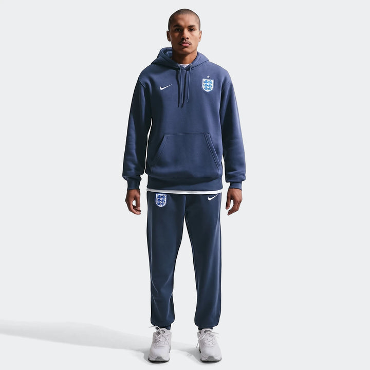 England Club Blue Men's Nike Soccer Pullover Hoodie and matching sweatpants worn by a model, full body front view.