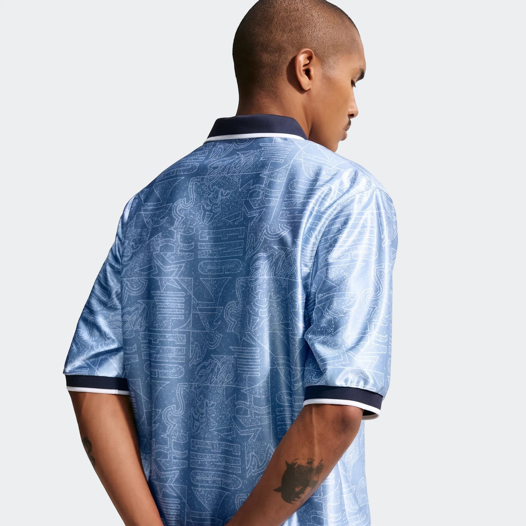 England Energy Men's Nike Dri-Fit Short-Sleeve Soccer Top in blue with a white pattern, viewed from the back on a model.