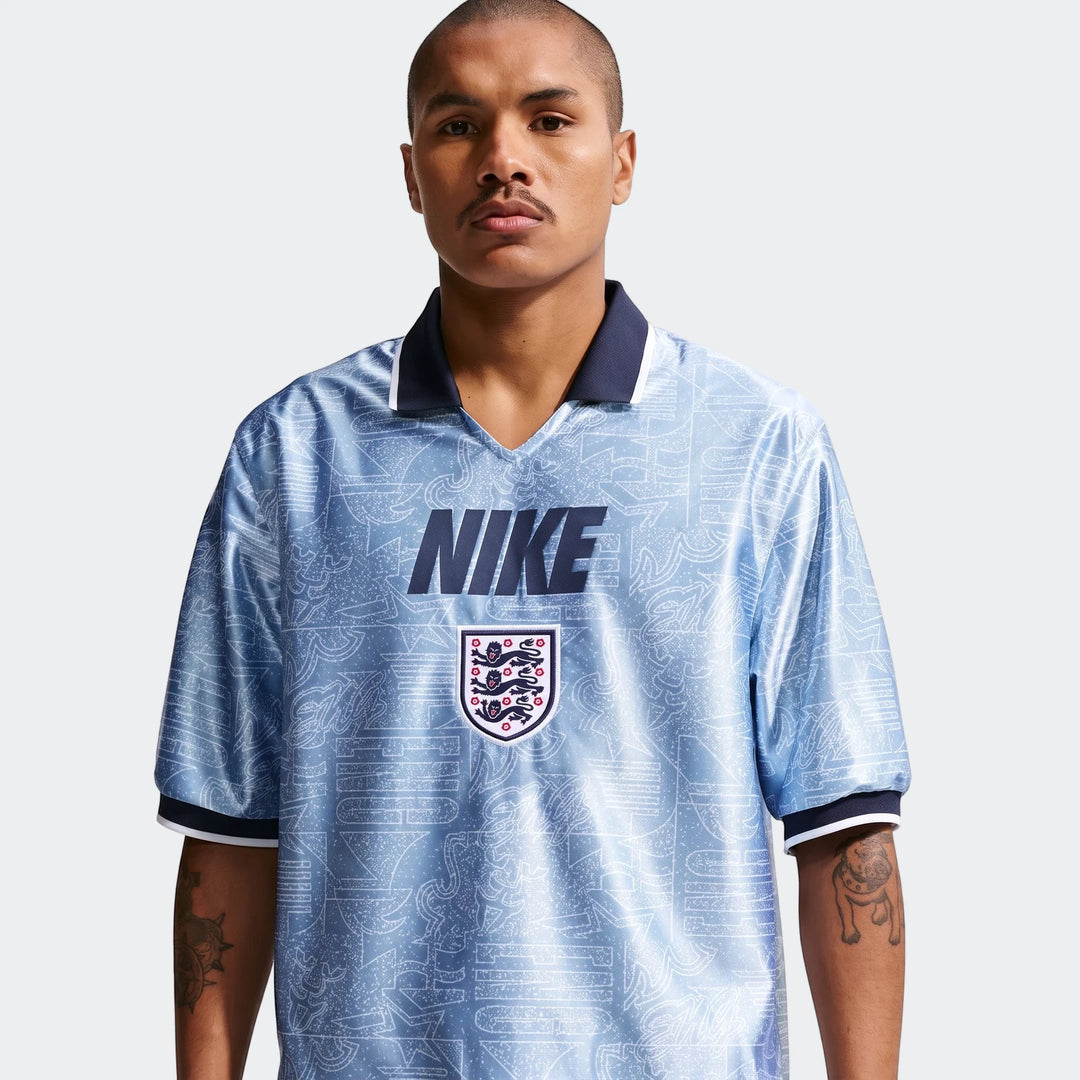 Light blue patterned England Energy Men's Nike Dri-Fit Short-Sleeve Soccer Top worn by a male model.