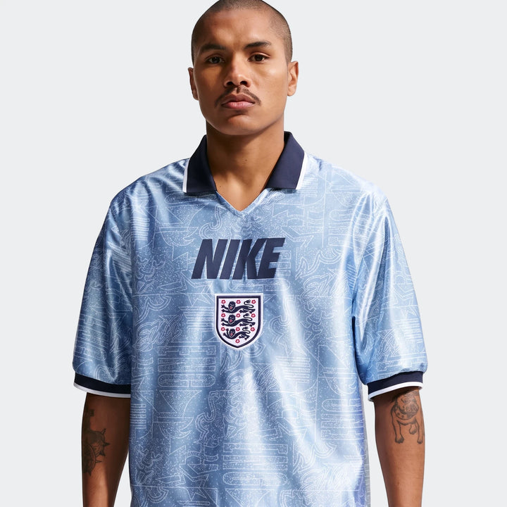 Light blue patterned England Energy Men's Nike Dri-Fit Short-Sleeve Soccer Top worn by a male model.