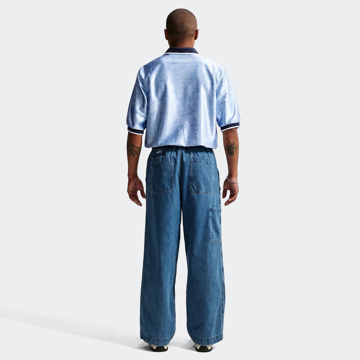Rear view of a man wearing an England Energy Men's Nike Dri-Fit short-sleeve soccer top in light blue with an intricate