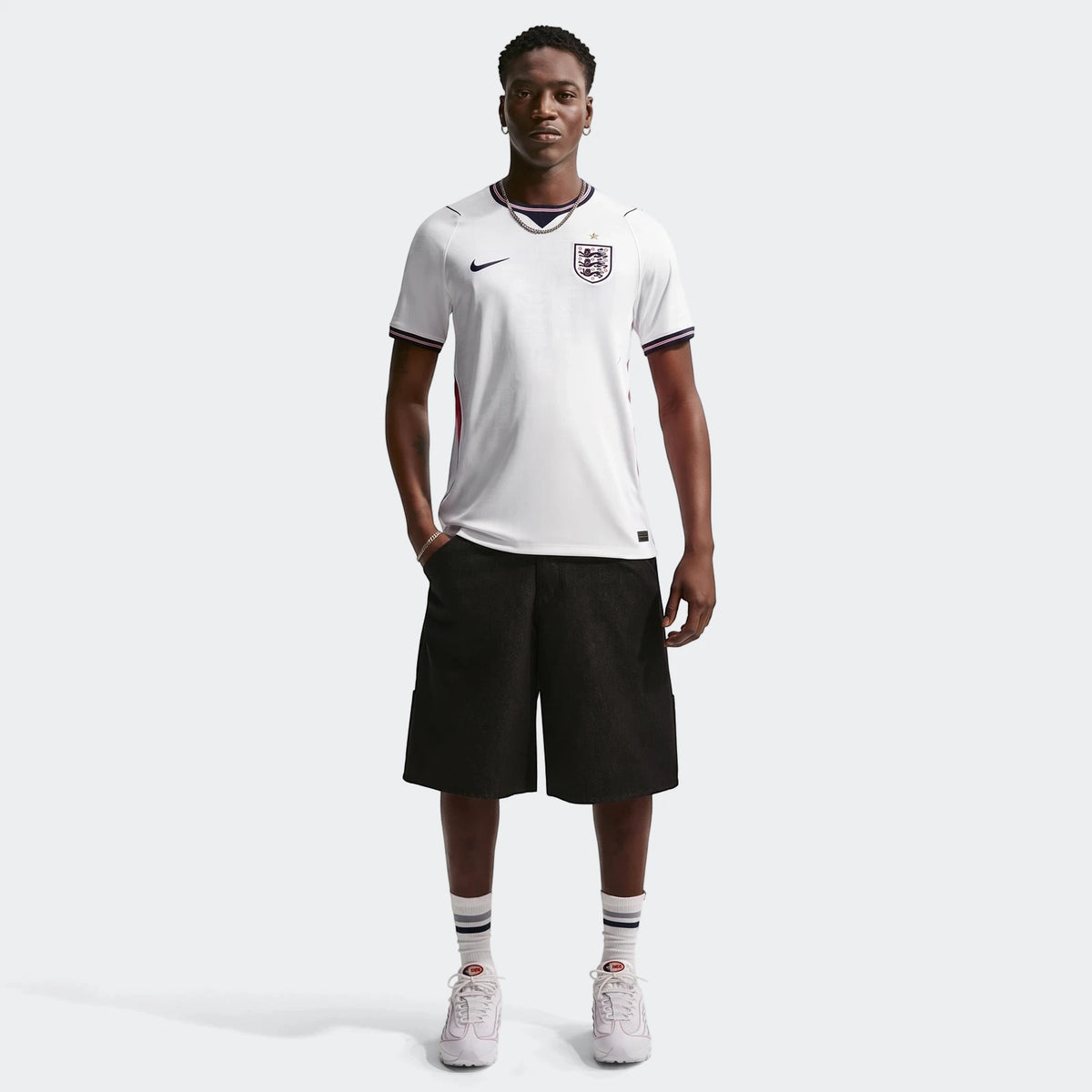 White Nike England National Team 2026 Stadium Home men's Dri-FIT soccer jersey, worn by a model in a full-body front view,