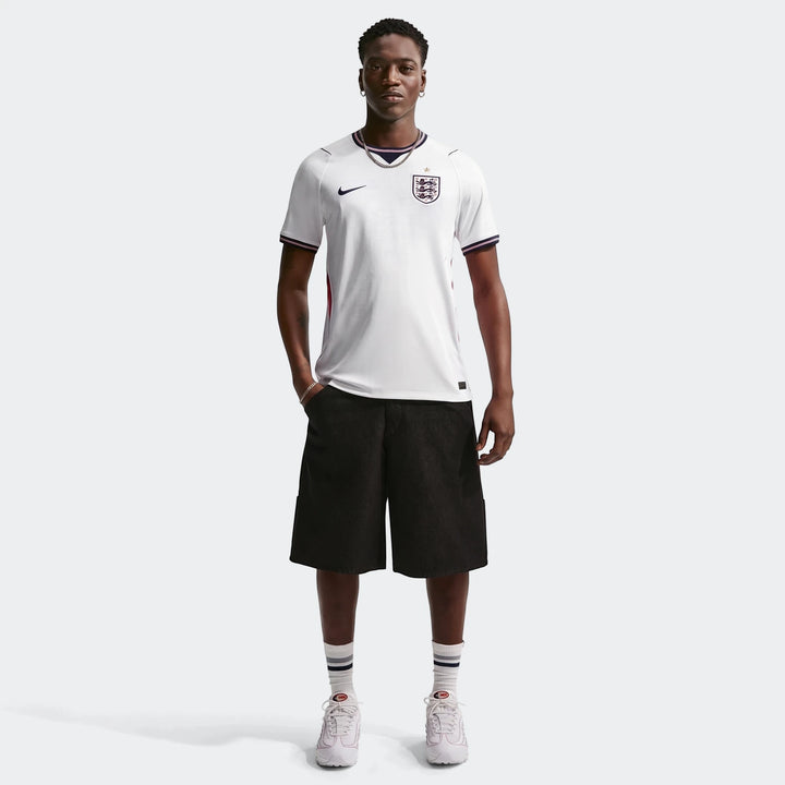 White Nike England National Team 2026 Stadium Home men's Dri-FIT soccer jersey, worn by a model in a full-body front view,