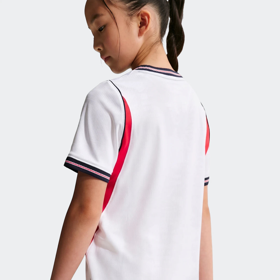 Young girl wearing a white, red, and navy England National Team 2026 Stadium Home Nike Dri-Fit Soccer Jersey, seen from the