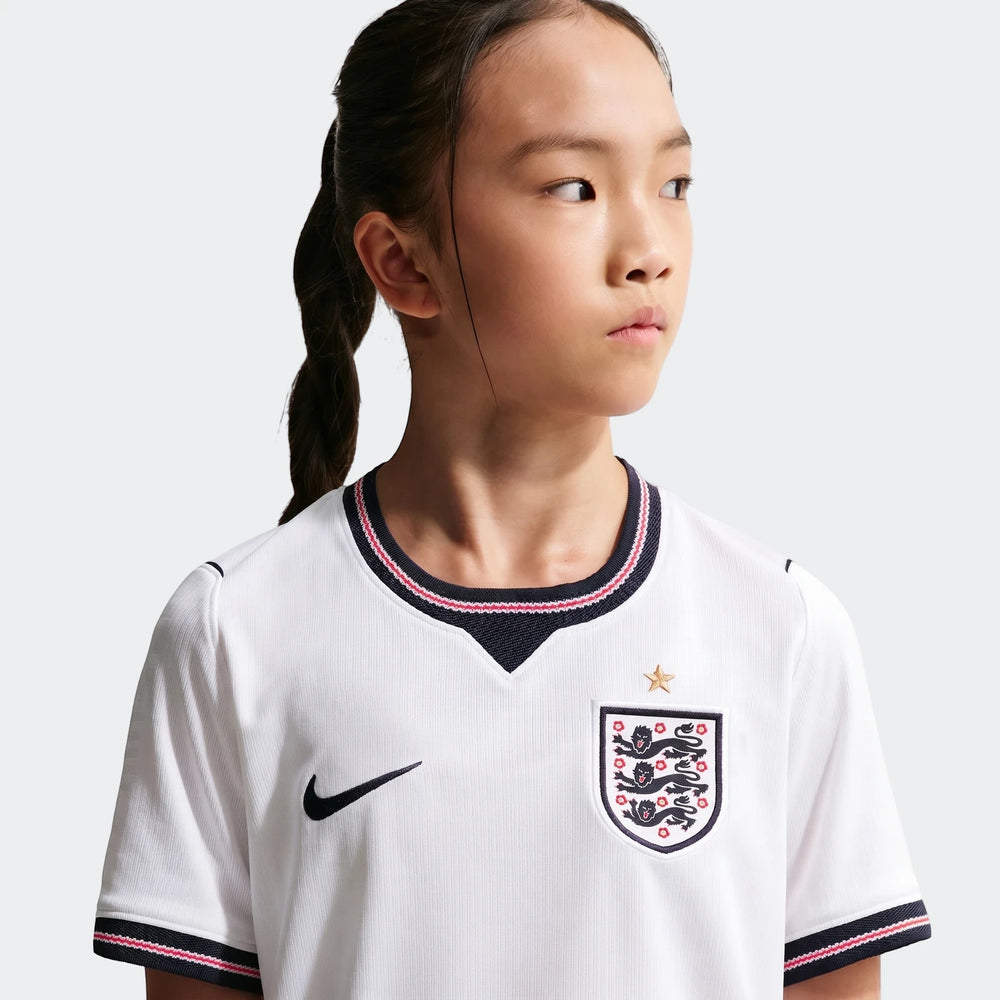Close-up of a young girl wearing the white England National Team 2026 Stadium Home Nike Dri-Fit Soccer Jersey, showing front