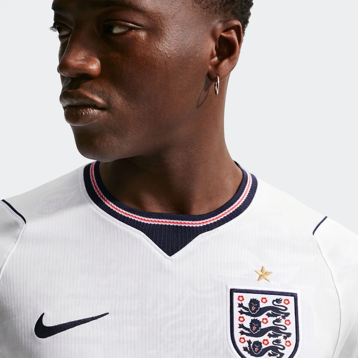 Close-up of a male model wearing the white England National Team 2026 Stadium Home Nike Dri-FIT soccer jersey.