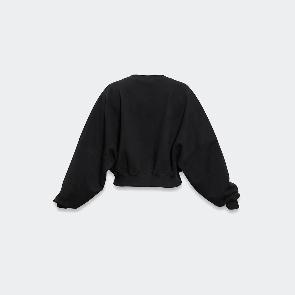 Black Essentials Fleece Crew Sweatshirt for women, featuring an oversized fit, wide raglan sleeves, and a ribbed hem, shown