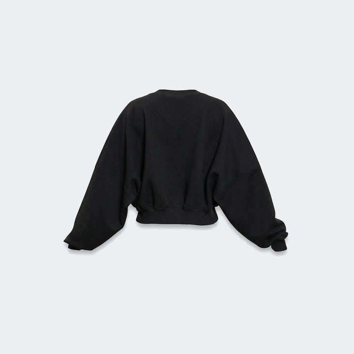 Black Essentials Fleece Crew Sweatshirt for women, featuring an oversized fit, wide raglan sleeves, and a ribbed hem, shown