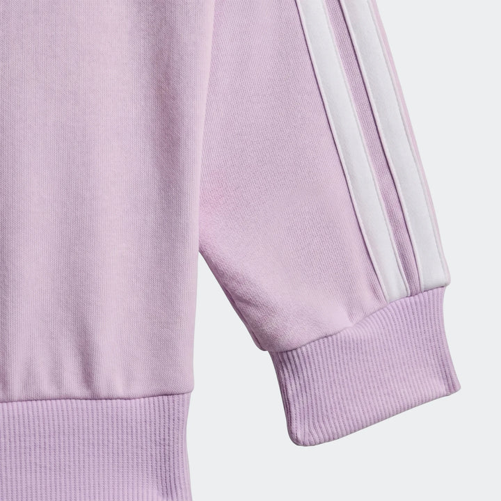 Close-up of a kid's lavender sweatshirt from the Essentials Joggers Set, featuring white stripes on the sleeve and ribbed