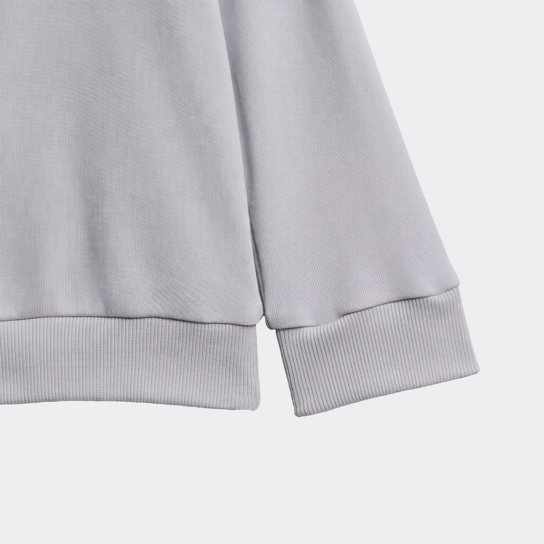 Light grey Essentials Kids long-sleeved top with ribbed cuffs and hem, showcasing the knit fabric texture.