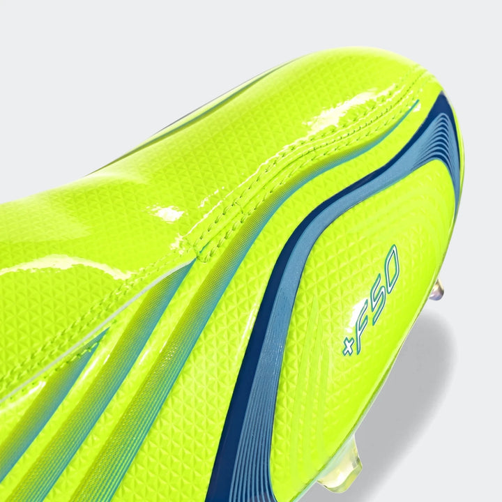 Close-up of a neon yellow F50 Elite Fg Tunit Football Boot with vibrant blue stripes and subtle texture details, showcasing