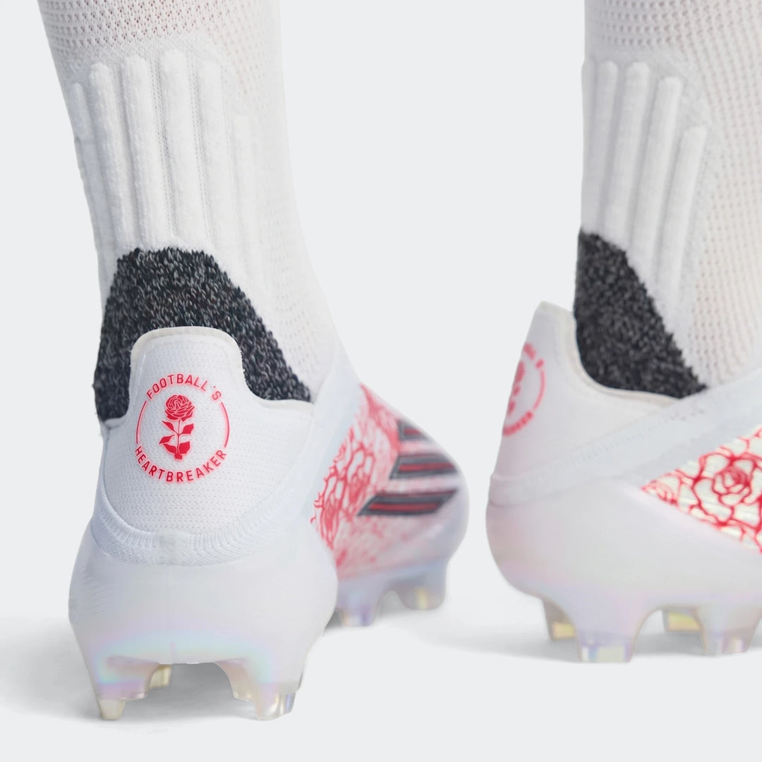 Rear view of white F50 Elite Ll Fg Lamine Yamal Football Boots featuring red rose graphics, worn with white socks.