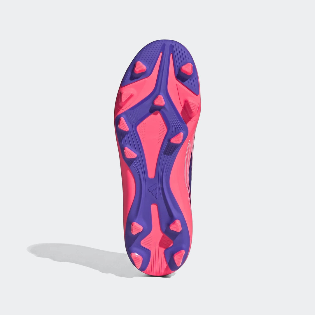 Kids F50 Hyperfast Club firm ground football boot, bottom view, featuring a striking pink and purple studded sole.