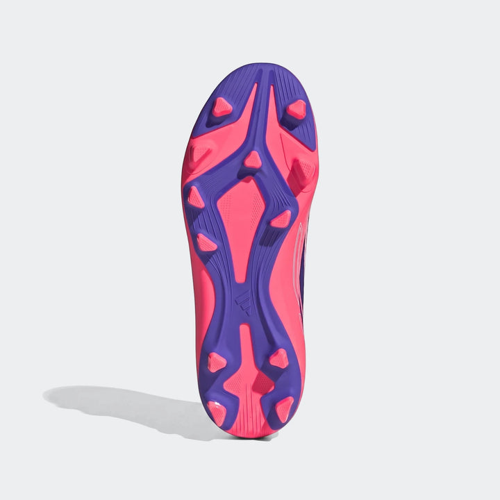 Kids F50 Hyperfast Club firm ground football boot, bottom view, featuring a striking pink and purple studded sole.