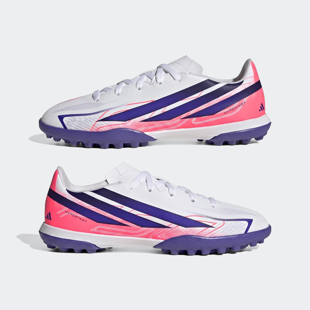 White, pink, and purple Adidas F50 Hyperfast Club Kids' Turf Football Boots, shown in a pair.