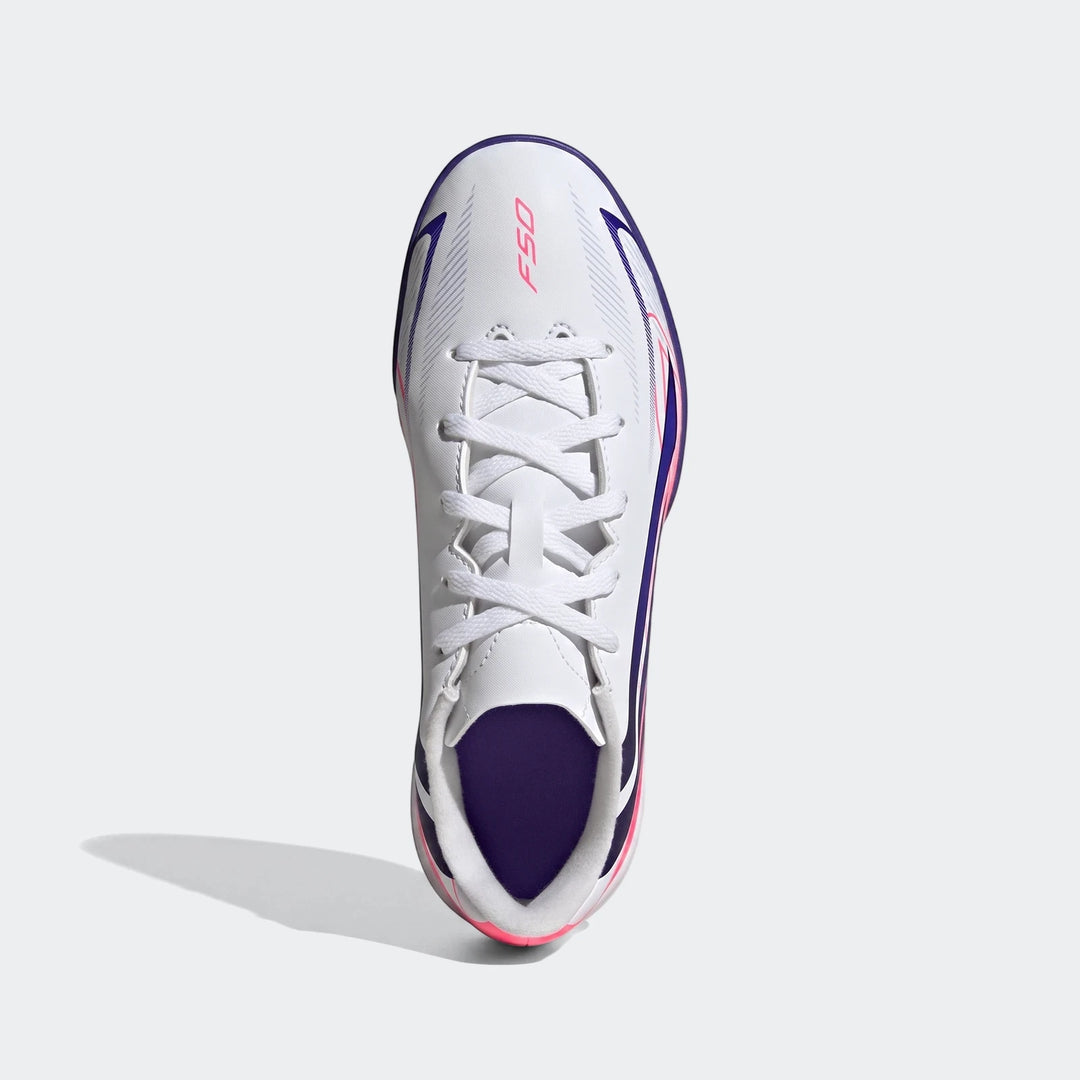 Kids F50 Hyperfast Club Turf Football Boots in white with pink and purple accents, shown from a top-down view.