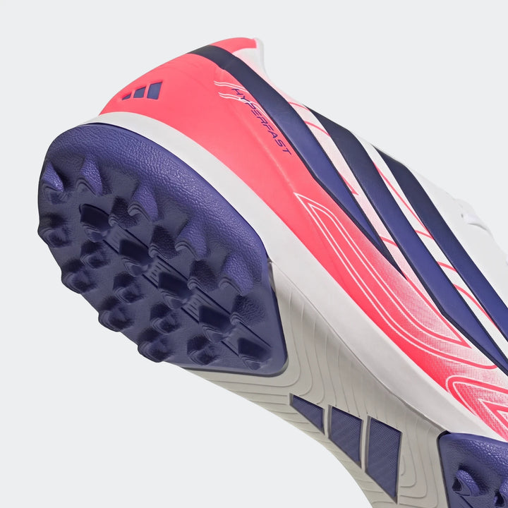 F50 Hyperfast Club Turf Football Shoe, featuring a vibrant pink and purple design with a white sole, shown in a close-up