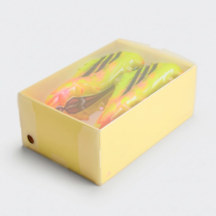 Neon yellow-green F50 Hyperfast Elite Firm Ground Football Boots stored inside a translucent plastic display box.