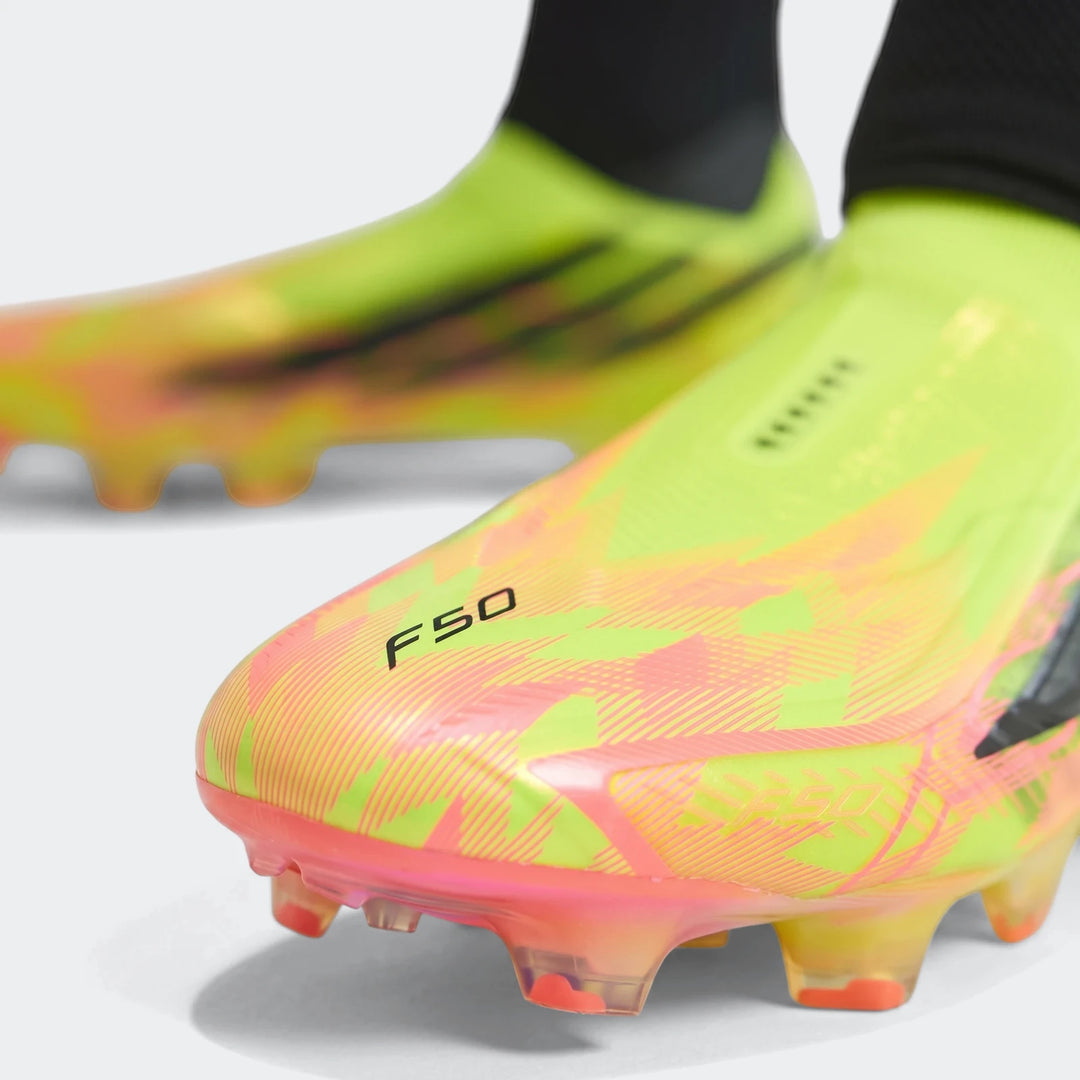 Close-up of F50 Hyperfast Elite Laceless Firm Ground Boots in vibrant neon green and orange with a patterned design, showing